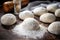 freshly rolled dough balls on a floured surface