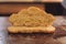 Freshly-sliced croissant, halved, placed on a rustic wooden table