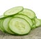 Freshly sliced cucumber on background.