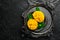 Freshly sliced mango on a metal plate. Tropical fruits. On a black stone background