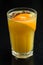 Freshly squeezed orange juice in a glass with a slice of orange