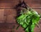 Freshly torn bunch of leafy red and green salad on a wooden table