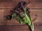 Freshly torn bunch of lettuce on a wooden table close-up