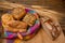 Freshly various buns in a basket and a half whole grain bread on a jute fabric