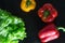 Freshly washed fresh vegetables over black background.