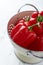 Freshly washed red peppers in a colander