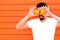 Freshness, healthy lifestyle, vitamines and energy concept: smiling man hiding eyes behind two big bright oranges. Copy space
