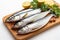 Freshness highlighted Raw mackerel fish on cutting board against plain white backdrop.