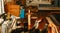 Fretboard gluing process, wood glue flowing on the neck of musical instrument - relatively wide angle of busy atelier workbench