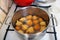 Fried balls are fried in oil on the stove. Preparing a homemade dessert on the traditional way