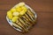 Fried baltic herring with boiled potatoes on a plate on wooden b