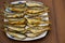 Fried baltic herring on a plate on wooden background