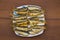 Fried baltic herring on a plate on wooden background