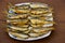 Fried baltic herring on a plate on wooden background