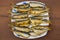 Fried baltic herring on a plate on wooden background