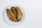 Fried bananas, banana fritters or pisang goreng on white background