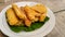 Fried bananas on a leaf on a plate for an afternoon snack