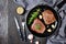 Fried beef steaks on a skillet, top view