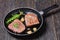 Fried beef steaks on a skillet, top view