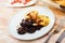 Fried blood sausage morcilla served with baked potatoes