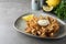 Fried blooming onion with dipping sauce served on grey table