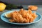 Fried blooming onion served on blue wooden table, closeup