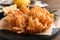 Fried blooming onion served on wooden table, closeup