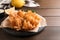 Fried blooming onion served on wooden table. Space for text