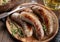 Fried bratwurst garnishrd with thyme