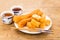 Fried bread stick or You Tiao served with Chinese tea on wooden table