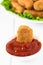 Fried Breaded Crispy Chicken Nugget Dipped in Ketchup