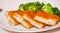 Fried breaded fish fillets with broccoli