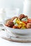 Fried Breaded Meatballs with Pappardelle Pasta, Vegetables and fresh Basil on bright wooden Background.