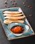 Fried Bruschetta with vegetable sauce in plate over dark background. Vegetarian food concept. Delicious snacks, crostini,