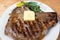 Fried bull meat on a plate with greens