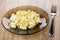 Fried cabbage with eggs in transparent plate and fork