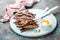 Fried capelin fish and butter sauce on a wooden plate