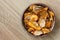 Fried carrot and parsnip chips in rustic wood bowl. From above.