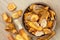 Fried carrot and parsnip chips in rustic wood bowl. From above.