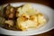 Fried cauliflower with wild porcini mushrooms and onions in a plate