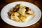 Fried cauliflower with wild porcini mushrooms and onions in a plate