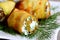 Fried cheese stuffed zucchini. Homemade fried zucchini rolls stuffed with cottage cheese and finely chopped dill on a white plate