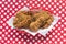 Fried chicken basket on red checkerboard tablecloth in center