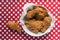 Fried Chicken basket on red and white checkered table with drumstick