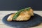 Fried chicken breast with fresh rosemary on small slate board