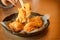 Fried chicken and chopsticks in black dish