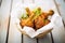 fried chicken drumsticks in a paper-lined basket