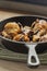Fried chicken drumsticks and sliced mushroom n a cast iron frying pan. On a chopping board