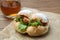 fried chicken hamburger lettuce on brown paper isolated on wooden table