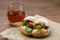 fried chicken hamburger lettuce on brown paper isolated on wooden table